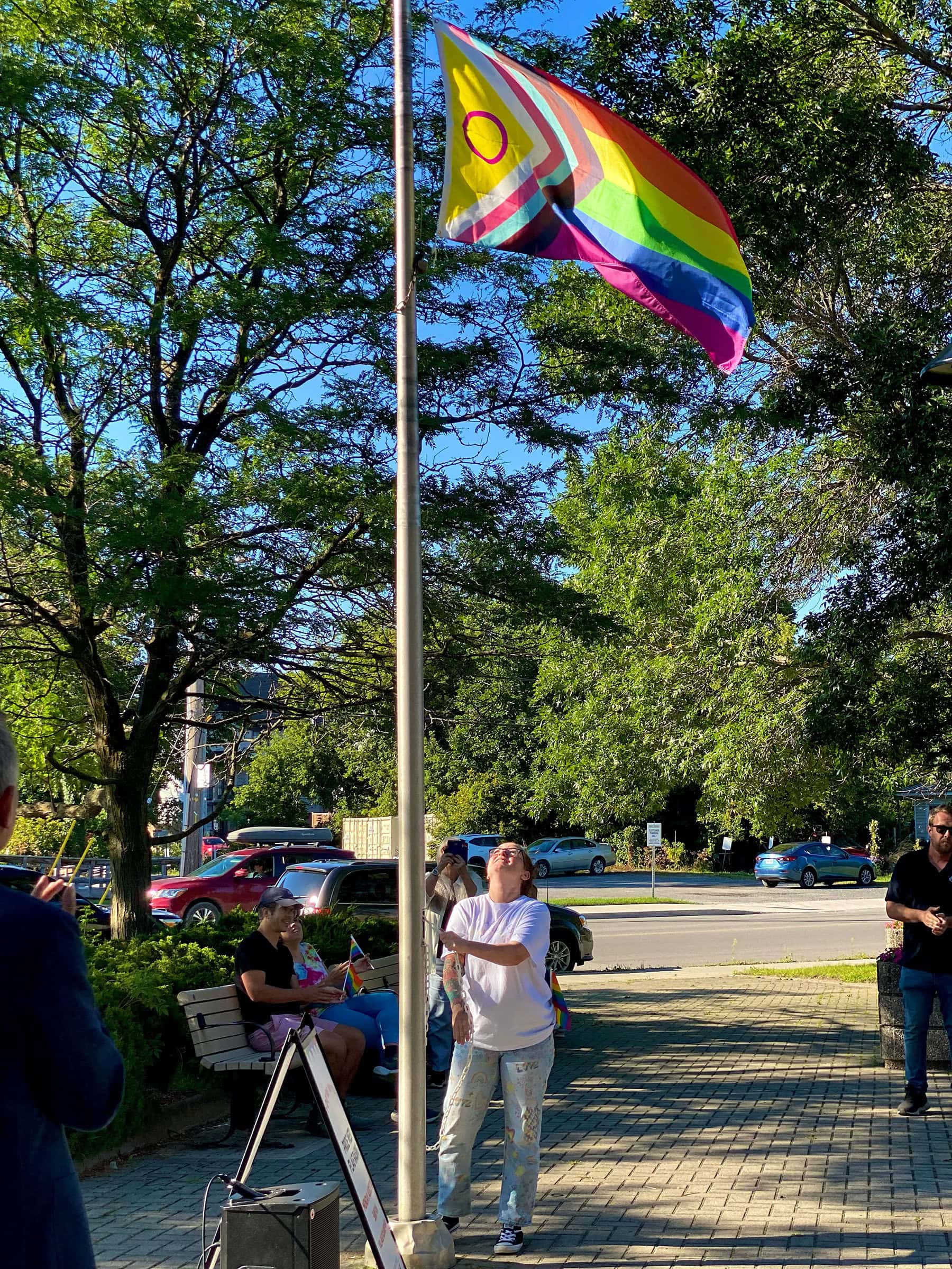 Kimberlee Barter raises the flag at the 2024 Pride Week flag raising ceremony in Stittsville 