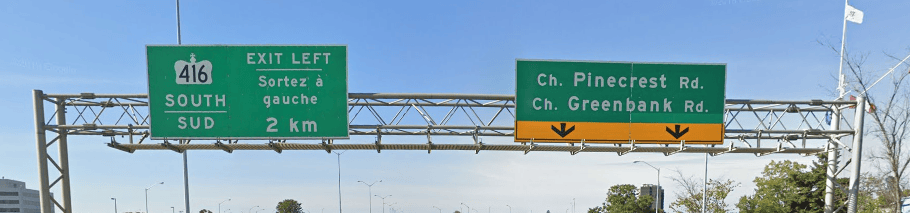 Photo of overhead highway signage. One indicates the direction of Highway 416 south, the other indicates the next exits to Pinecrest and Greenbank. Both signs are grene with white text.