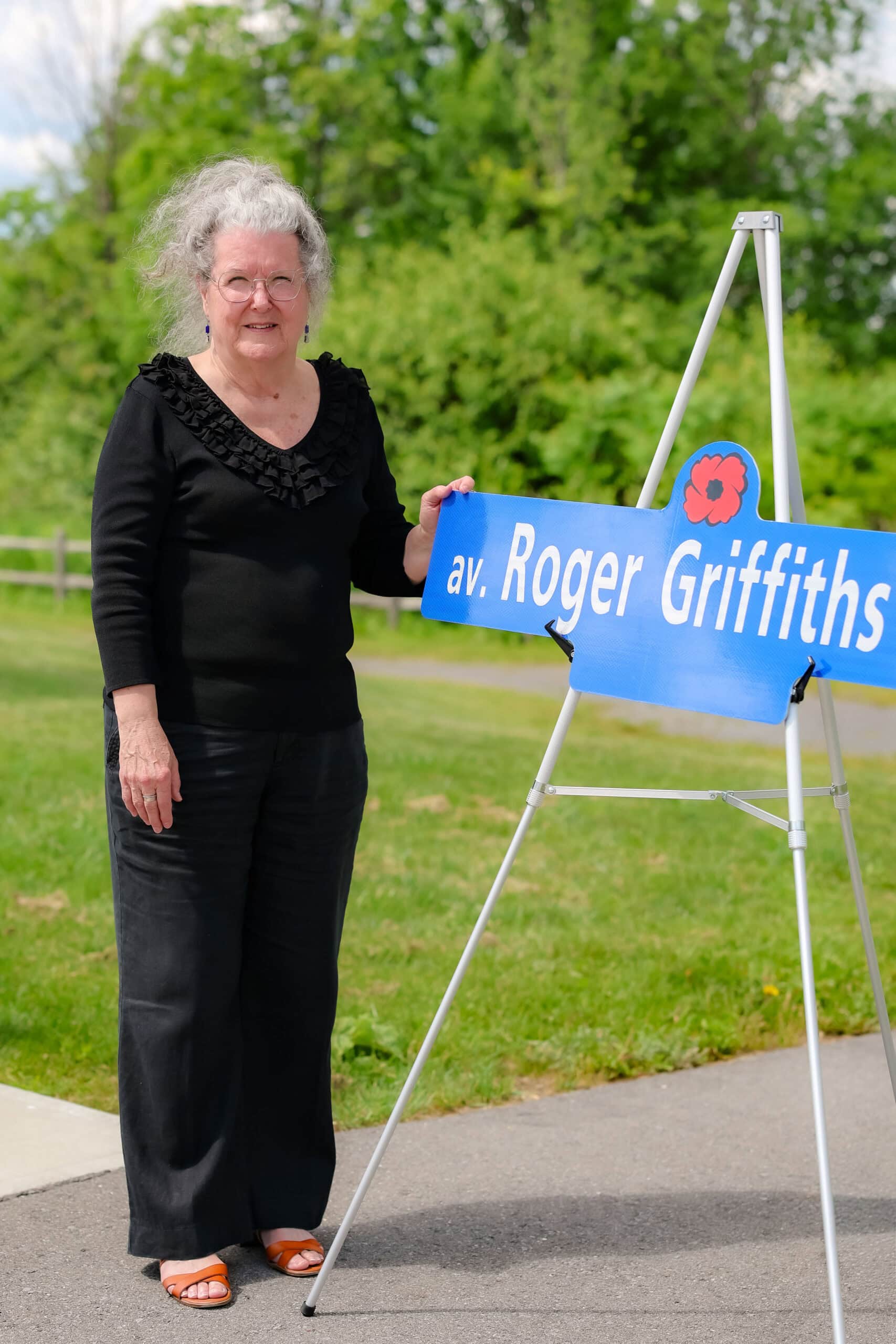 Roger Griffiths Avenue street naming ceremony. Lynn Griffiths with a replica sign