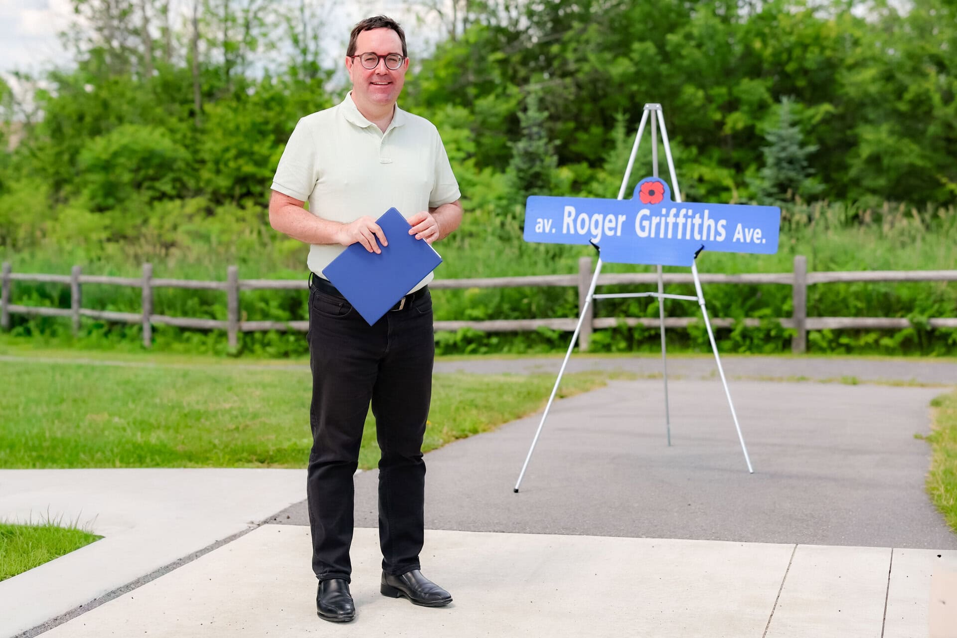 Roger Griffiths Avenue street naming ceremony. Councillor Glen with the Roger Griffiths sign
