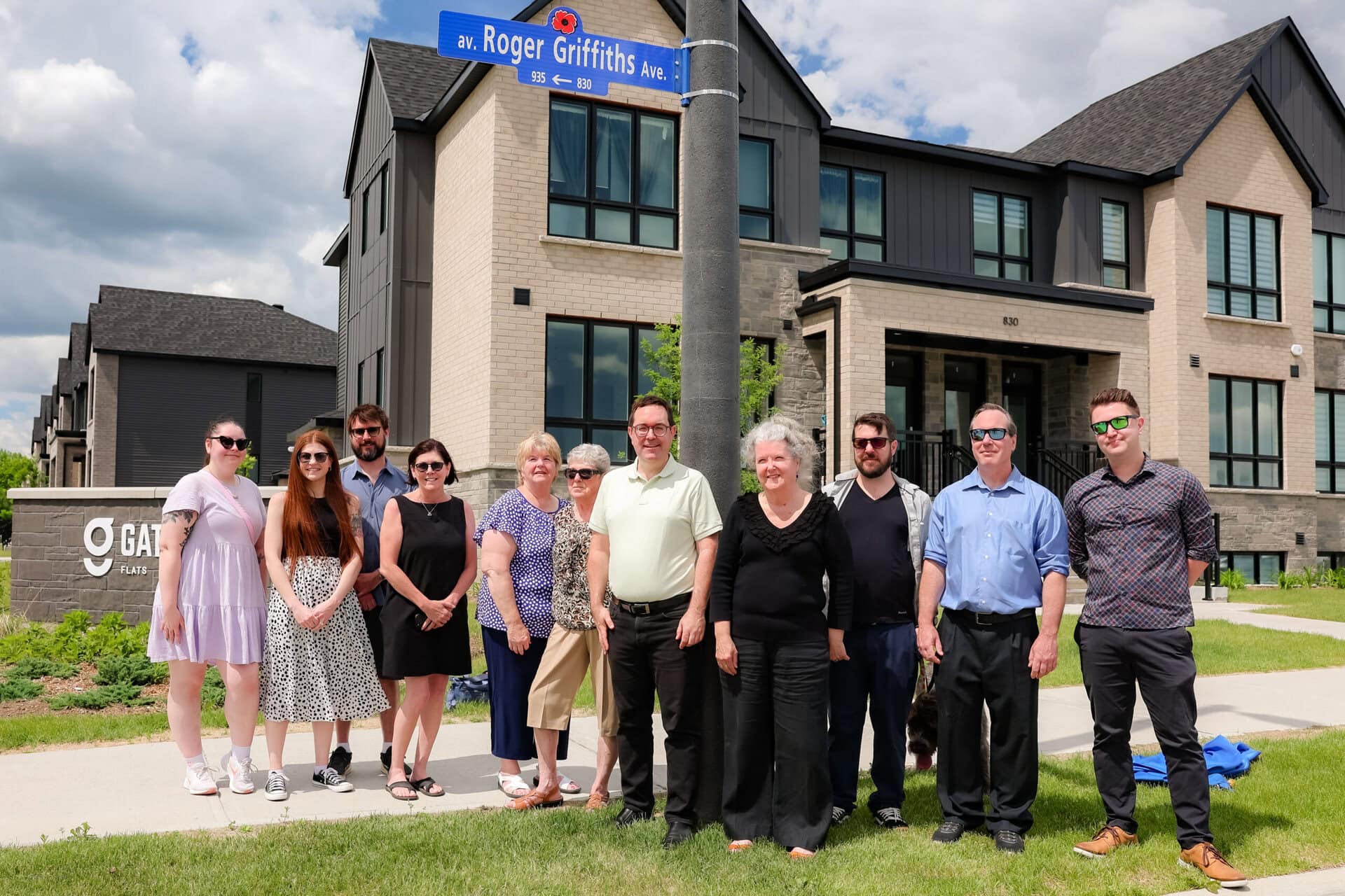 Roger Griffiths Avenue street naming ceremony. Family photo around the sign